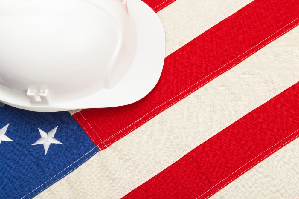 White contractor hat on top of American flag