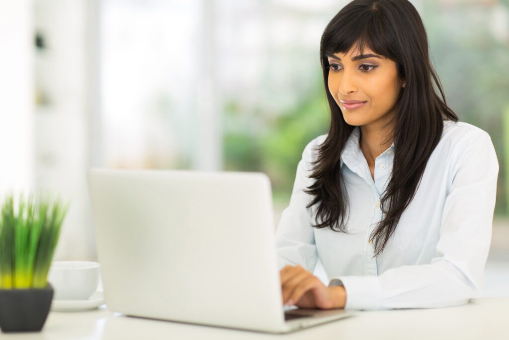 Young professional woman using laptop