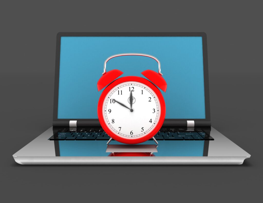 Graphic illustration of red alarm clock on open laptop